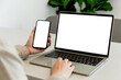 © panitan - computer screen,cell phone blank mockup.hand woman work using laptop texting mobile.white background for advertising,contact business search information on desk in cafe.marketing,design