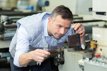 man fixing a machine