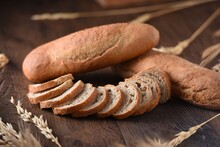 Homemade Dark Bread Cutted Into Slices On Dark Background. Bakery Product