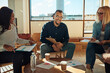 © Flamingo Images - Smiling young businessman meeting with colleagues in an office