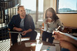 © Flamingo Images - Laughing businesspeople having a meeting together in an office