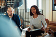 © Flamingo Images - Smiling African American businesswoman having a meeting with office colleagues