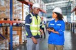 © Tongpool - Warehouse worker standing discussion talking stock check and key information to tablet pc