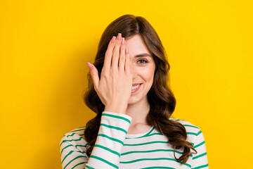 Poster - Portrait of positive satisfied pretty cheerful optimist attractive woman cover eye vision checkup ophthalmology isolated on yellow color background