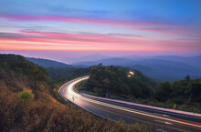 Beautiful Sunrise And  Car Lights On The Road At Doi Inthanon National Park At Night On Mount Inthanon Doi Inthanon National Park, Chiang Mai, Thailand