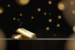 3D rendering of gold bars on black background with golden bokeh