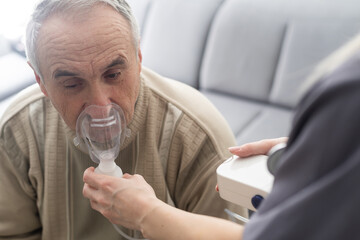 elderly senior man nursing care wear oxygen inhaler device for helping breath respiratory. oxygen co