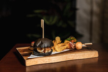 Seafood Charcoal Burger With Potato Chip On Wooden Board