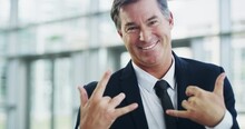 Rock On Gesture By A Funny, Happy And Confident Business Man While Walking Through A Work Office. Portrait Of A Goofy, Positive And Charming Professional Smiling After Good News, Promotion Or Success