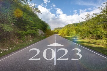 Wall Mural - 2023 number written on road with nature background