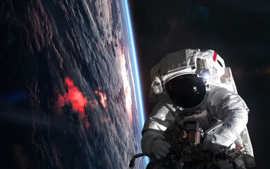 Wall Mural - astronaut in outer space orbiting planet earth. solar system. science fiction. elements of this imag