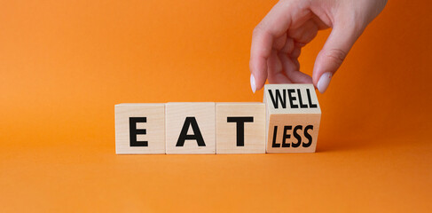 Eat less vs Eat well symbol. Doctor hand Turnes cube and changes word Eat less vs Eat well. Beautiful orange background. Psychology Medical concept. Copy space