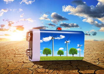 Wall Mural - battery with wind turbines on the dry cracked soil at sunset.