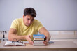 © Elnur - Young male student sitting in the classroom