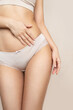 © Mykola - Thin young woman in underwear on beige background. Fitness, diet, skin and body care