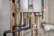 Condensing tankless hot water heater connected to a recirculation system and storage tank