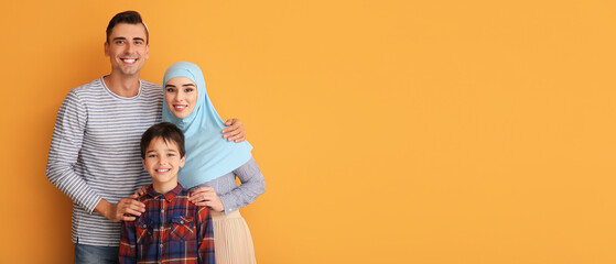 Wall Mural - Portrait of Muslim family on orange background with space for text