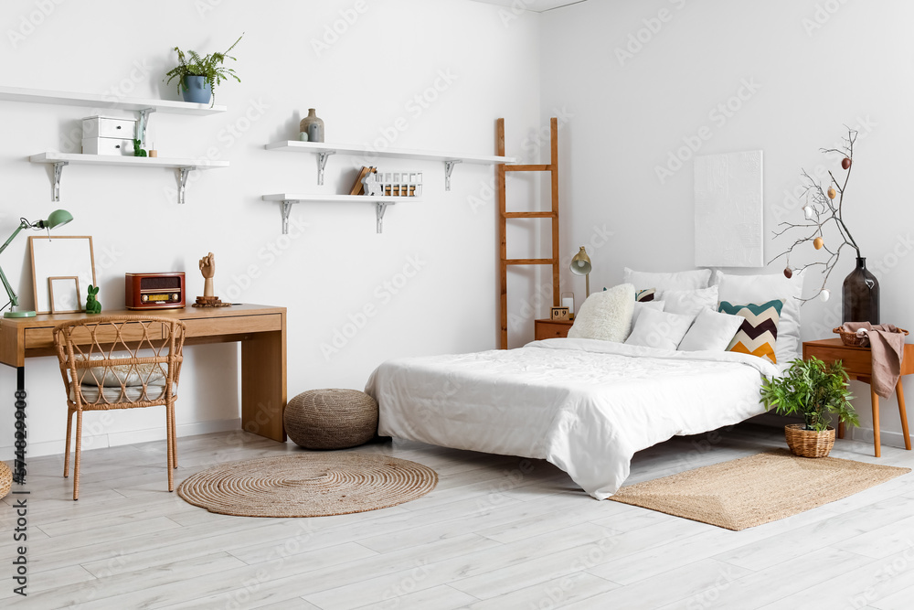 Stylish interior of light bedroom with Easter decor and comfortable bed