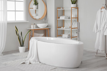 Poster - Stylish interior of bathroom with modern bathtub, sink and shelving units with accessories