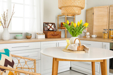 Wall Mural - Vase with tulips, basket of Easter eggs and rabbit on dining table in kitchen