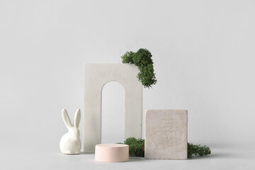 composition with podiums, easter bunny and moss on white background