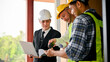 © bongkarn - Caucasian businessman is pleased with the building process, and meets with the construction team
