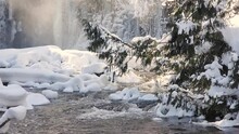 Dreamy Wintery Fast-flowing Creek That Runs Through The Frozen Landscape In The Forests Of Canada