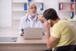 © Elnur - Young male patient visiting old male doctor