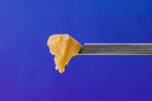 Live Rosin On A Dab Tool With A Blue Background