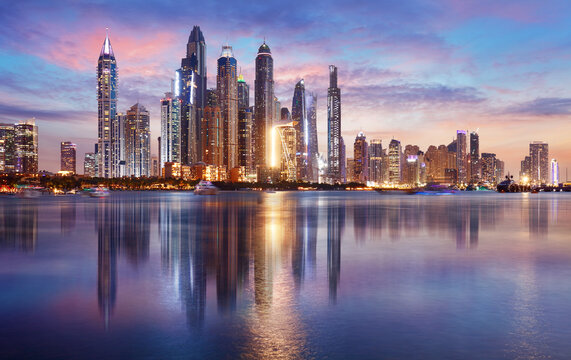 dubai panorama skyline at dramatic sunset in marina, united arab emirates
