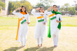 © GAJENDRRA BHATI  - Three young beautiful women wearing traditional white dress holding indian flag and saluting.standing at park celebrating Independence day or Republic day.