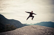 © Cavan Images - Hiker jumping