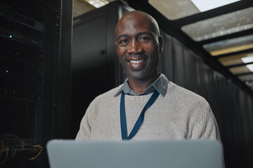 Sticker - Laptop, portrait and IT black man in server room for research, engineer working in dark data center lobby. Face, cybersecurity or analytics with male programmer problem solving or troubleshooting