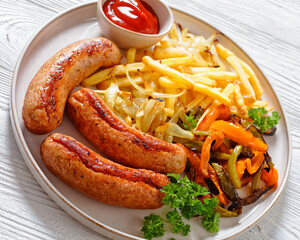 Canvas Print - Grilled sausages, peppers, onion and french fries