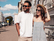 © halayalex - Smiling beautiful woman and her handsome boyfriend. Woman in casual summer clothes. Happy cheerful family. Female having fun. Sexy couple posing in the street at sunny day. In hat and sunglasses