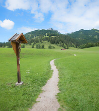Hiking Path Hochkreuth, With Wayside Cross, Green Pasture And Mountain View
