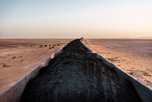 Iron Ore Train Passing In Desert Terrain