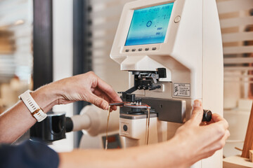 Canvas Print - Lens machine, glasses and hands of optometrist for eyeglasses, prescription and vision frames in clinic. Healthcare, ophthalmology and optician working on eyesight, eye care and medical eyewear