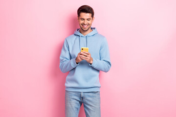 Sticker - Photo of confident pretty guy dressed blue sweatshirt typing message modern gadget isolated pink color background