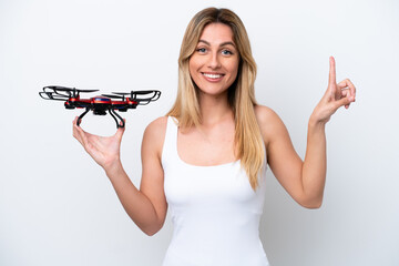 Canvas Print - Young Uruguayan woman holding a drone isolated on white background pointing up a great idea