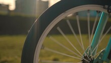 Bike Wheel Rotation At Sunset Girl Cycling In Scenic City Landscape At Sunset Slow Motion. Happy Childhood, Sports Outdoors In Playground