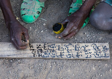Afar Tribe Teacher Writing On A Wood Board In A Coranic School, Afar Region, Afambo, Ethiopia