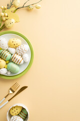 Wall Mural - Easter atmosphere concept. Top view vertical photo of crockery with lot of colorful easter eggs knife fork and easter bouquet on isolated pastel beige background