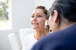 © Austockphoto - Female patient having her ears checked by a female nurse using an otoscope in the clinic