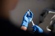 © Austockphoto - Close up shot of a syringe being inserted to a medicine glass vial by a healthcare worker