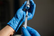 © Austockphoto - Close up shot of a syringe being inserted to a medicine glass vial by a healthcare worker