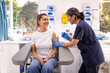 © Austockphoto - Female patient getting an injection on the arm by a female healthcare practitioner in a clinic
