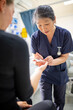 © Austockphoto - Health worker getting a blood sample to a woman using a blood lancet in the clinic