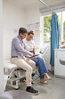 © Austockphoto - Male doctor holding a tablet  and talking to a female patient in the clinic