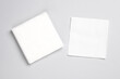 White paper napkins on gray background. Top view
